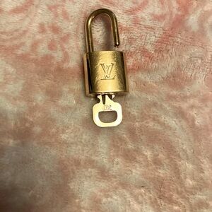Authentic Louis Vuitton lock and key number 307 . Some scratches gently loved